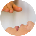 therapist's hand performing Reiki above a female patient's face